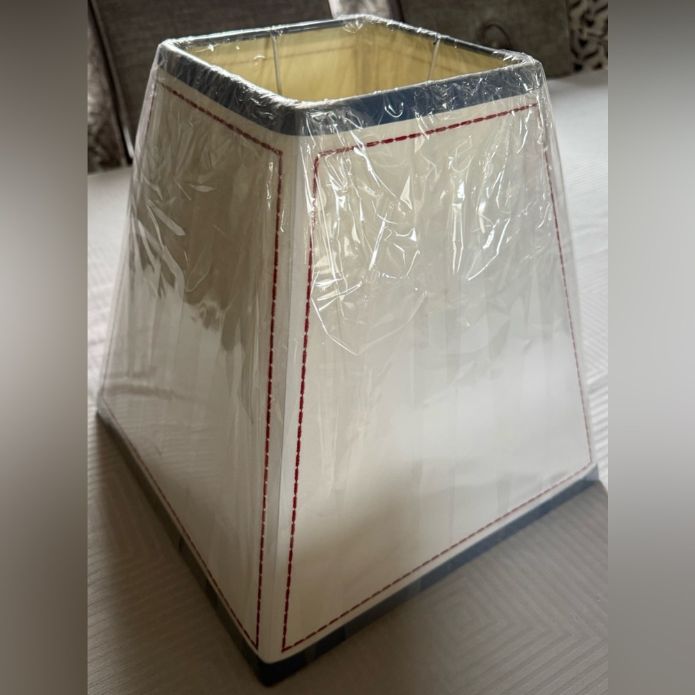 Trapezoid shape w/blue border, red stitch outline. Base: 12 x 12in, Top: 6 x 6in